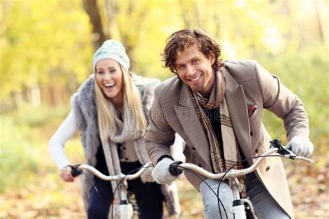 Happy Couple On Bikes In Forest During Fall Time Stock Image Image Of