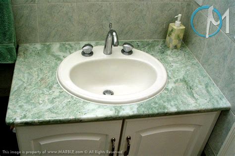 Because of it's polished finish, it is not recommended in wet rooms, such as bathrooms and kitchens, due to it's high slip factor. This simple vanity is made of Ming Green marble. The light ...