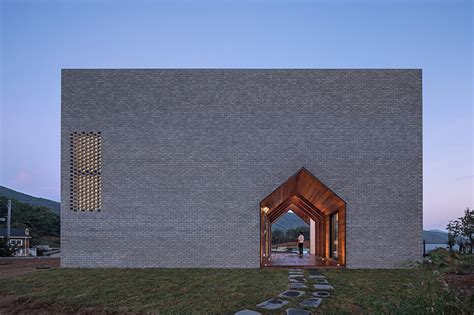 Vernacular Void Wood Walls Warm Negative Space In Gray Brick Home