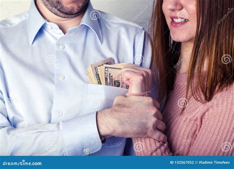 Young Wife Pulls Out Dollar Bills From Her Husband`s Shirt Pocket The Husband Grabbed Her Hand