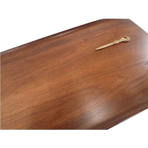 It is made of beautiful walnut with stunning wood grain. Bassett Mid-Century Walnut Surfboard Coffee Table | Chairish