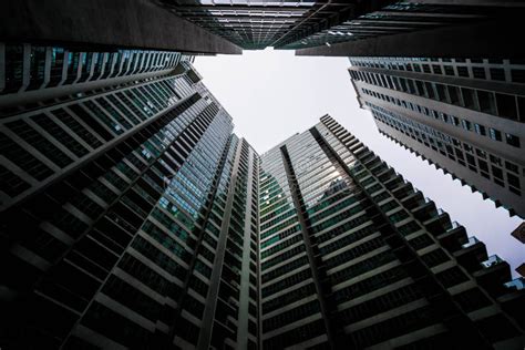 Low Angle Shot Of Modern Glass City Buildings With Clear Sky Background