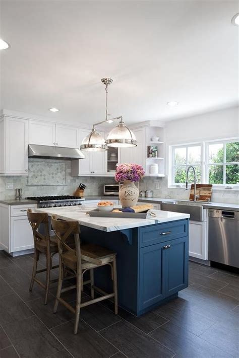 Accent colors include a deep brown range hood, black kitchen island, and deep grey marble countertops. 25 Contrasting Kitchen Island Ideas For A Statement - DigsDigs