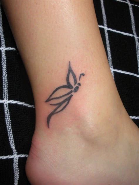 Butterflies, a broken watch and a girl's face drawn in this cool back tattoo. 30 Simple Unique Tattoo Designs for Girls 2019 - SheIdeas
