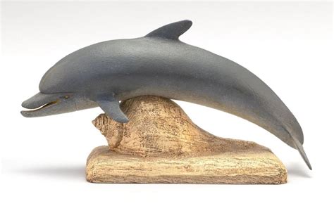 Lot Robert Innis Carving Of A Dolphin Mounted On A Carved Conch Shell