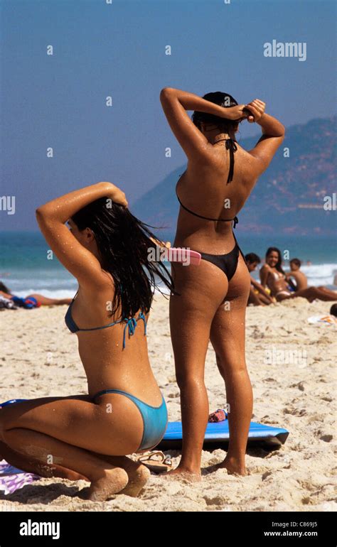 Rio De Janeiro Brazil Two Women In Bikinis On Ipanema Beach Stock