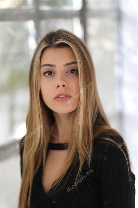In this hairstyle for dark brown eyes, a balayage consisting of light blondes and dark browns can be seen combining into beautiful blends. Head Shot of a Beautiful Blond Woman with Brown Eyes ...
