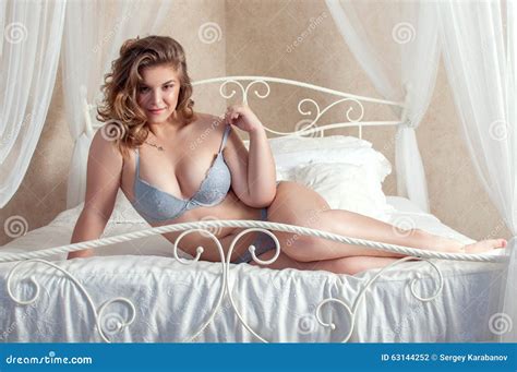 Plus Size Playful Girl Lying In Bed Stock Photo Image Of Heeps Woman