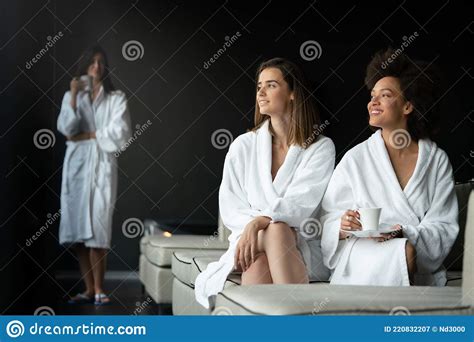 Lesbian Couple Relaxing And Drinking Tea In Robes During Wellness Weekend Stock Image Image Of