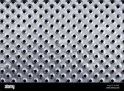 Silver Colored Metal Background With Holes Stock Photo Alamy