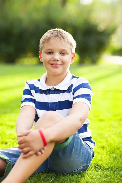 Little Boy Sitting On The Grass With Smile Stock Image Image Of Park