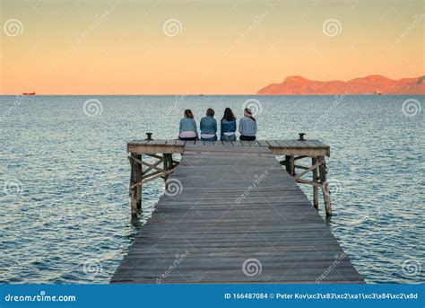 Women Sitting On The Pier And Talk Together Mallorca Spain Summer