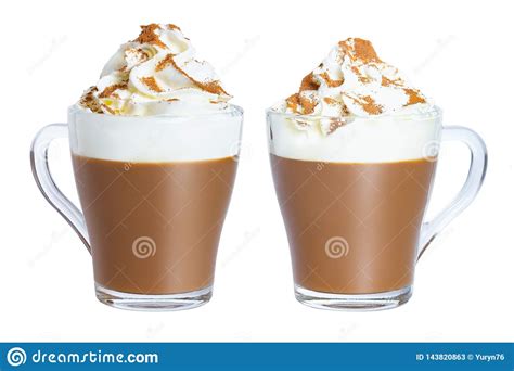 Cappuccino Coffee With Whipped Cream And Cinnamon In A Glass Mug The