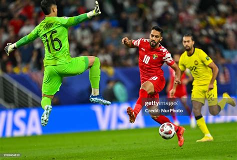 Mousa Altamari Of Jordan Is Battling For The Ball With Ahmad Syihan
