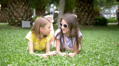 Two Cute Girls Relax In The Park On The Grass Stock Image Image Of