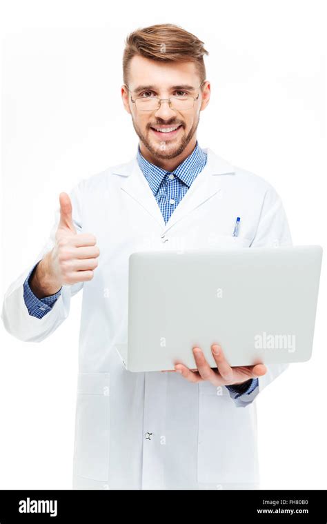 Happy Male Doctor Holding Laptop Computer And Showing Thumb Up Isolated