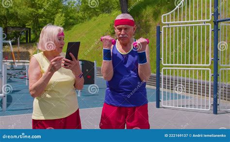 Senior Old Woman Grandmother Coach Teaching Grandfather With Sport
