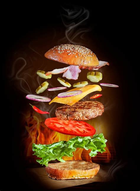 Flying Burger Ingredients With Bacon On A Black Background Stock Photo