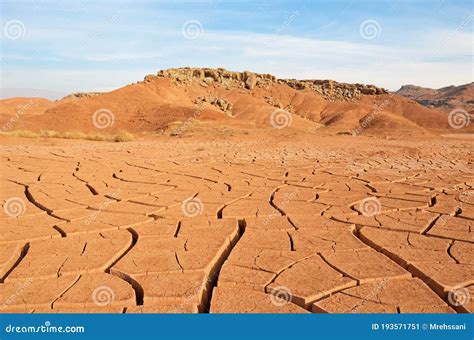 The Landscape Of Dry Mountains And Mud Cracked Pattern On Desert Ground