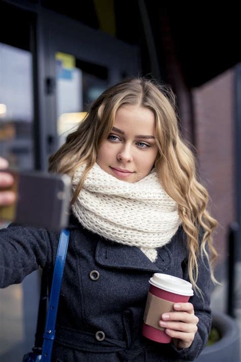 Beautiful Happy Blonde Young Caucasian Woman Taking A Selfie On Smartphone Outdoors In Park In