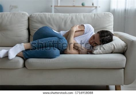 Depressed Young Woman Lying On Couch Stock Photo Edit Now 1716918088