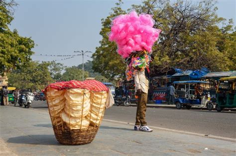 Seller Carrying Sweets Cotton Candy Taffy And Toys On The Street In
