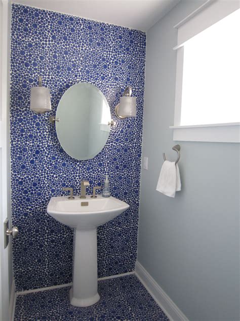 To support your makeup activity, get task lighting in both sides of wall mirror. Powder Room with blue ceramic pebble tiles on floor and up ...