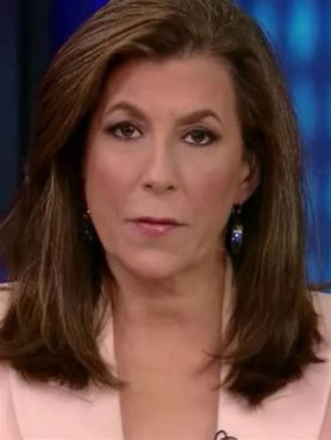 A Woman In A Pink Jacket And Earrings On The Set Of News Talk With Abc