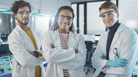 Laboratory With Team Of Three Young Scientists Working Stock Image