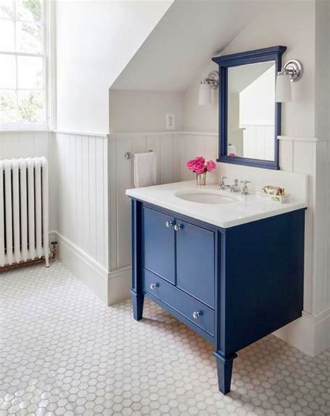 Notes of black add a graphic touch that highlights the beautifully laid out blue tile accents and enhances the overall design of the room. 10 Navy Blue Bathroom Ideas