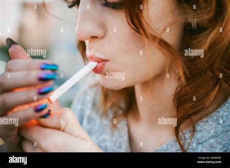 Close Up Of Woman Lighting Cigarette In City Stock Photo Alamy