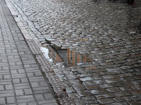 Wet Paved Gray Paving Road With Puddles On The Street Stock Image