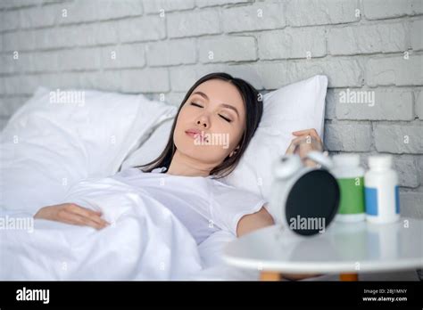Brunette Female Sleeping Peacefully In Her Bed Stock Photo Alamy