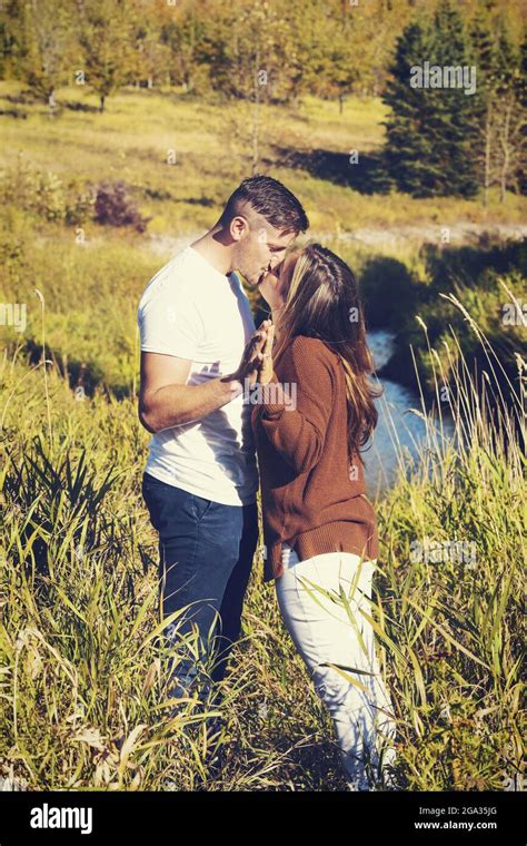 Husband And Wife Spending Quality Time Together And Kissing Outdoors