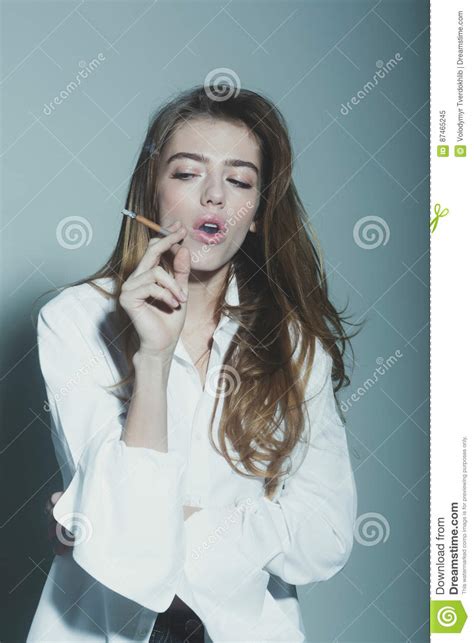 Pretty Woman Or Girl With Long Hair Smoking Cigarette
