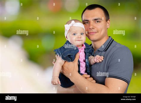 Happy Young Man Holding A Baby Stock Photo Alamy