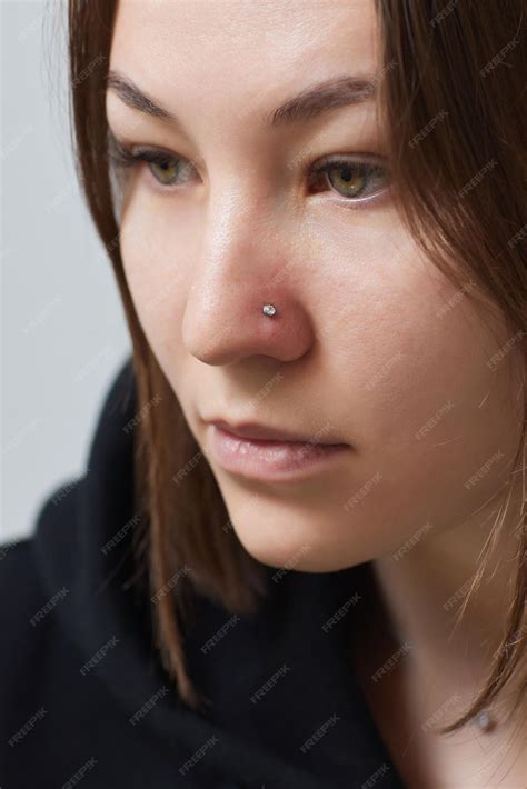 Premium Photo Closeup Of A Young Womans Visage With Piercing Hanging From Her Nose