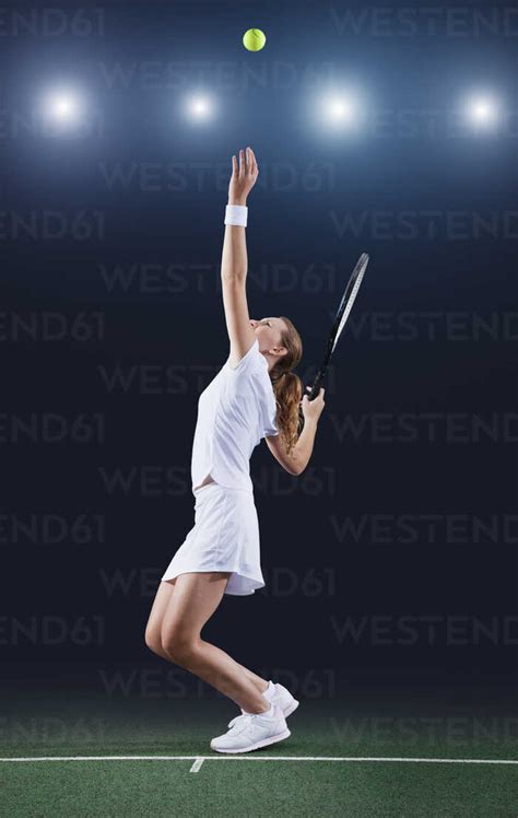 Tennis Player Serving Ball On Court Stock Photo