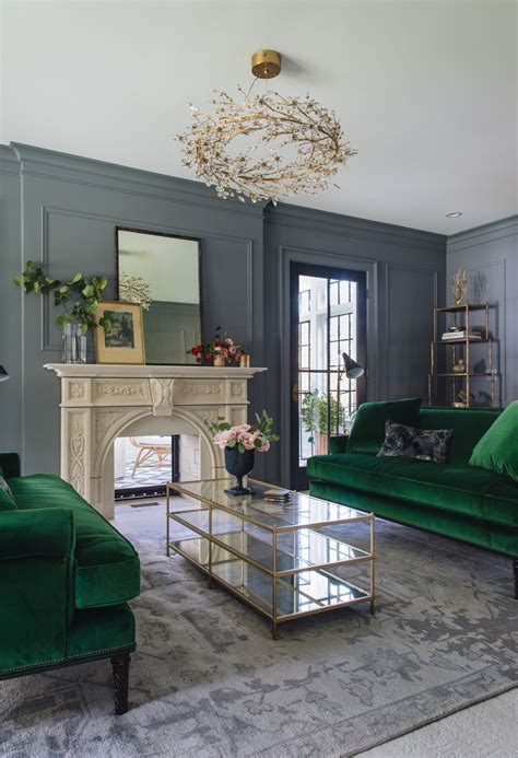 Emerald green sofas are bold scandinavian style pieces of furniture that will deliver a maximalists look to your home. GREEN sofas!, grey walls, vertical mirror over fireplace ...