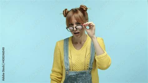 Young Woman With Bangs Wearing Casual Clothes Take Off Glasses And