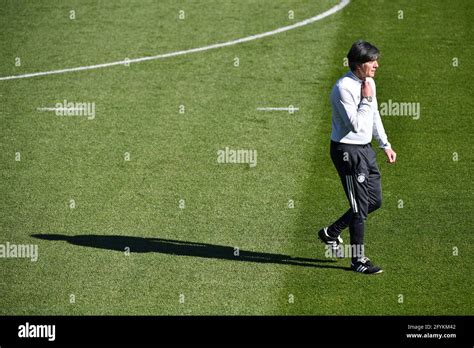 federal coach joachim jogi loew low ger walks across the square casting shadows single