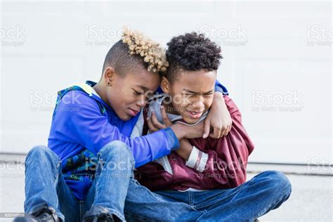 Boy Crying Brother Comforting Him Stock Photo Download Image Now