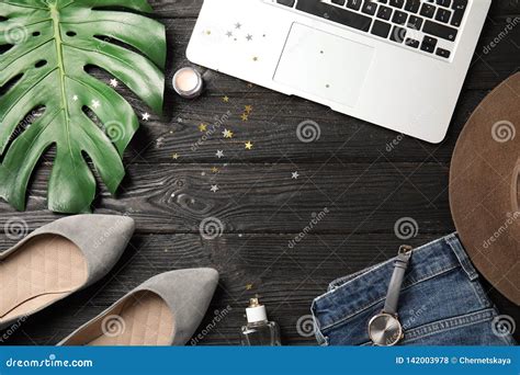 Flat Lay Composition With Laptop And Stylish Clothes Stock Photo