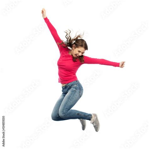 Smiling Young Woman Jumping In Air Stock 사진 Adobe Stock