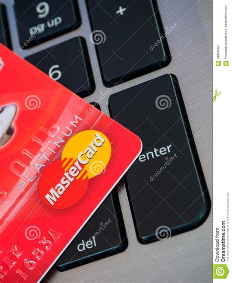 Get your debt usage now » Bangkok, Thailand - Jun 23, 2016 Red Credit Card With MasterCard Logo On Computer Keyboard ...