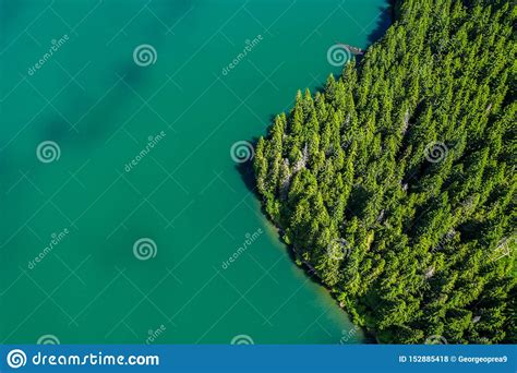 Mountain Lake With Turquoise Water And Green Trees Reflection In The