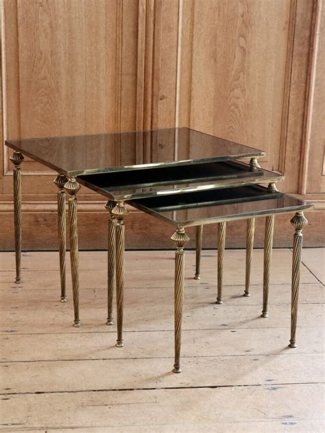 Berny is a table with an incredibly simple and linear design with solid walnut structure. Mid century Brass nesting tables with mirrored tops ...