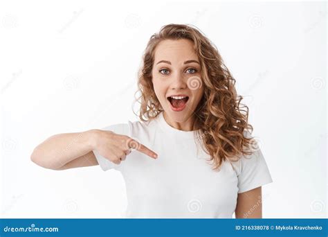 Portrait Of Blond Excited Woman Pointing Finger At Copy Space Logo