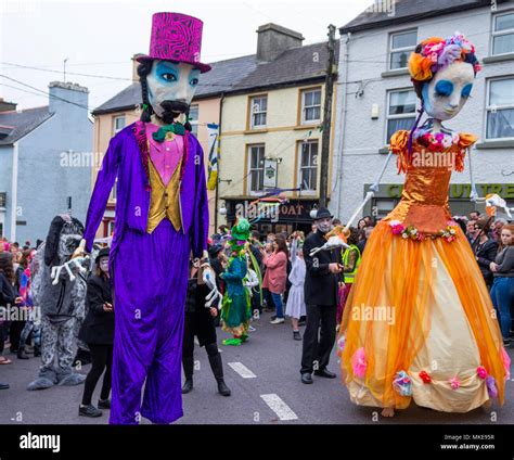 Brightly Coloured Giant Puppets Taking Part In A Street Procession