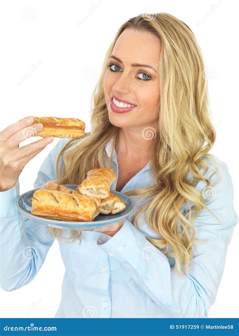 Young Woman Holding And Eating Freshly Baked Saugage Rolls Stock Image